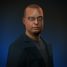 A Sri Lankan man with glasses and a casual dark-coloured suit.