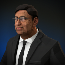 An older Indian man wearing a suit