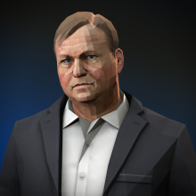 A heavyset Russian man with gray hair wearing a suit without a tie.